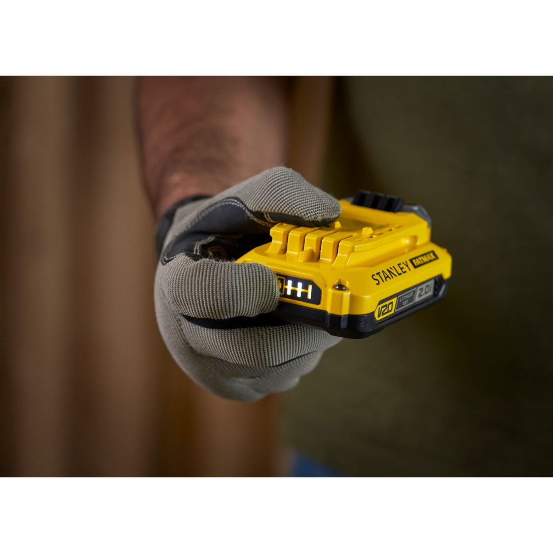 Stanley FatMax V20 2.0Ah battery held in gloved hand