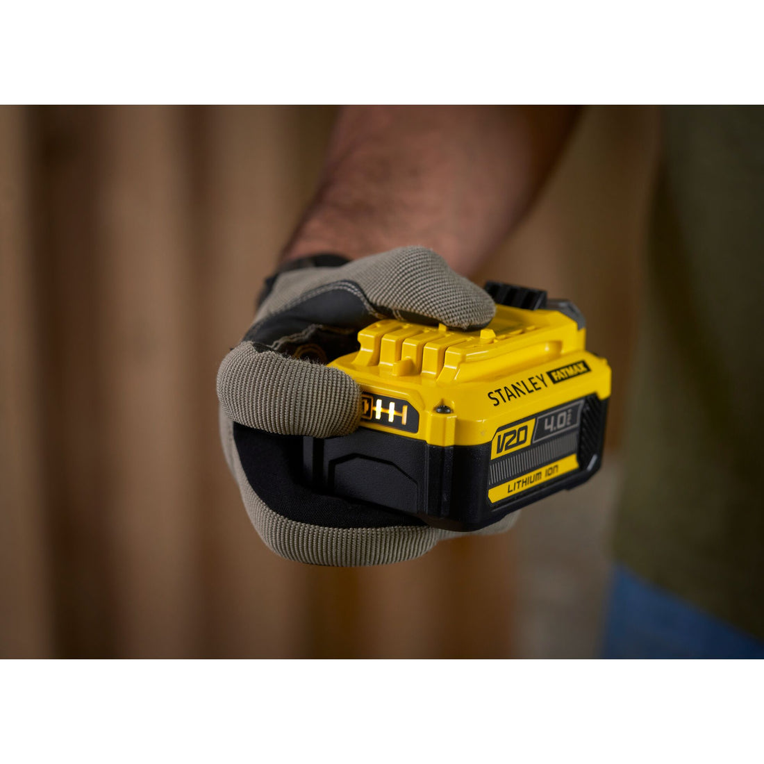Stanley FatMax V20 4.0Ah battery held in gloved hand