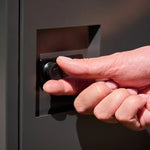 Empire Parcel Letterbox in grey steel, close up of a hand turning the combination lock dial