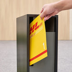 Swift Letterbox in grey steel, front mail slot with a hand posting a DHL Express envelope