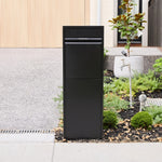 Zip Parcel Letterbox in black installed streetside beside a driveway and garden bed at a home entrance.