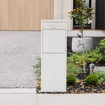 Zip Parcel Letterbox in white installed beside a driveway and garden bed at a home entrance.