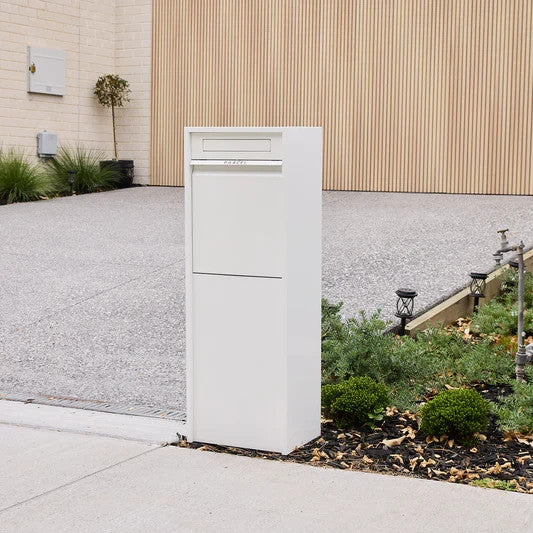 Zip Parcel Letterbox in white installed at a home entrance beside a paved driveway.