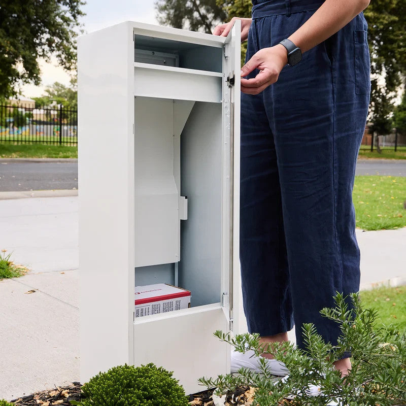 Zip Parcel Letterbox in white with the door open and a person standing beside it near a front fence.