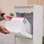 Zip Parcel Letterbox in white with a courier satchel and envelope being placed into the open parcel slot.