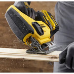 Person using a yellow and black jigsaw power tool on a wooden surface